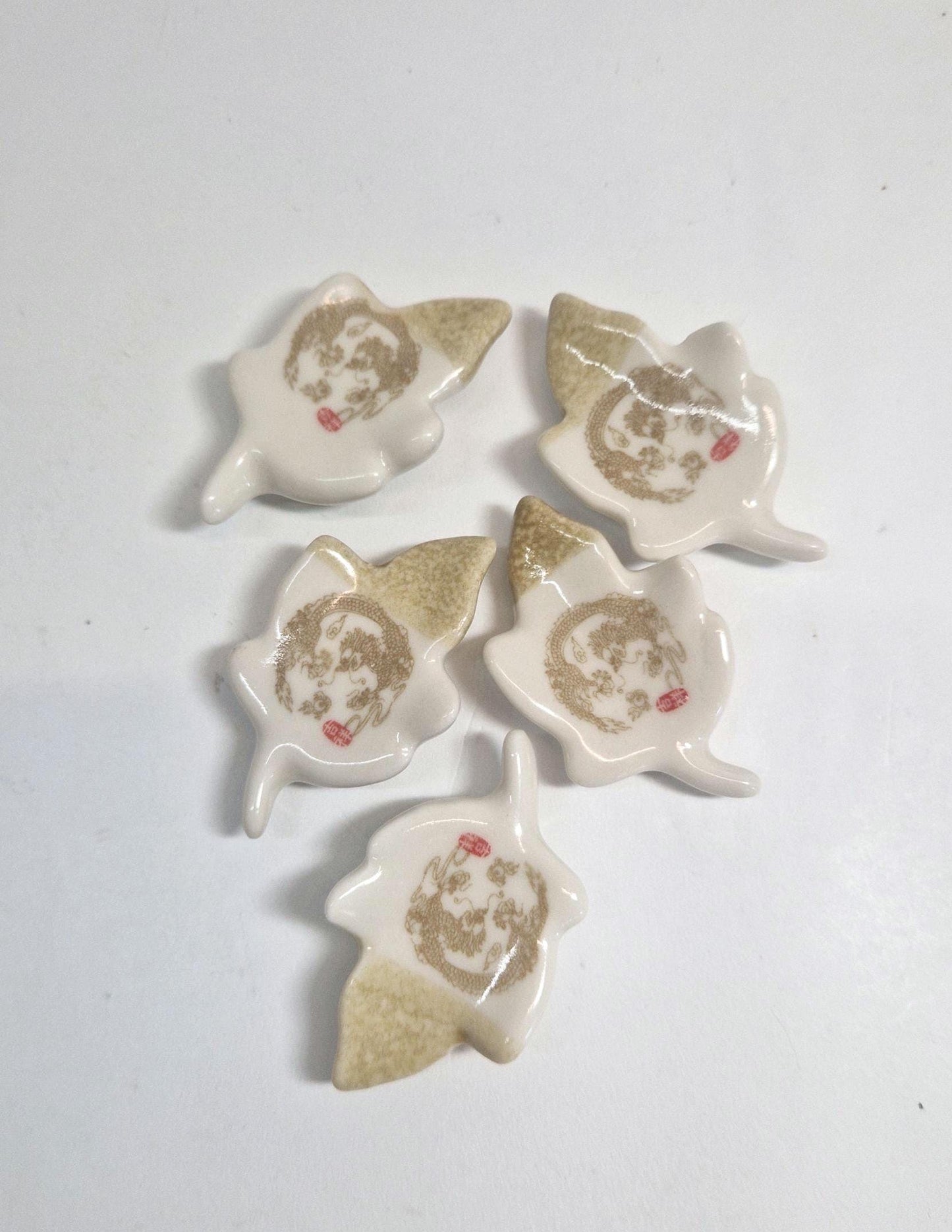 5 Chopstick Holders, Leaf Shaped with Dragon Design in Cream and Beige.
