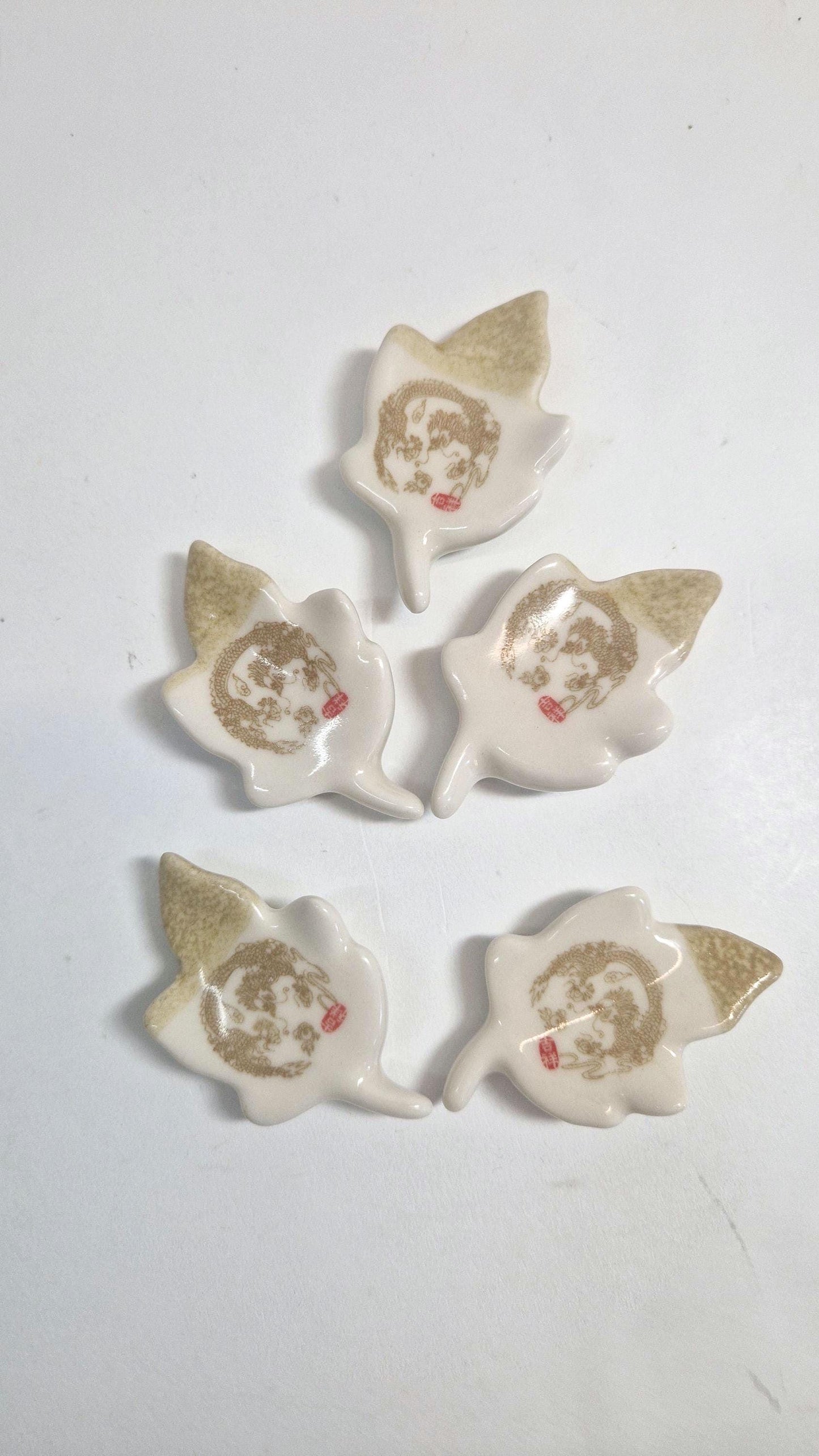 5 Chopstick Holders, Leaf Shaped with Dragon Design in Cream and Beige.