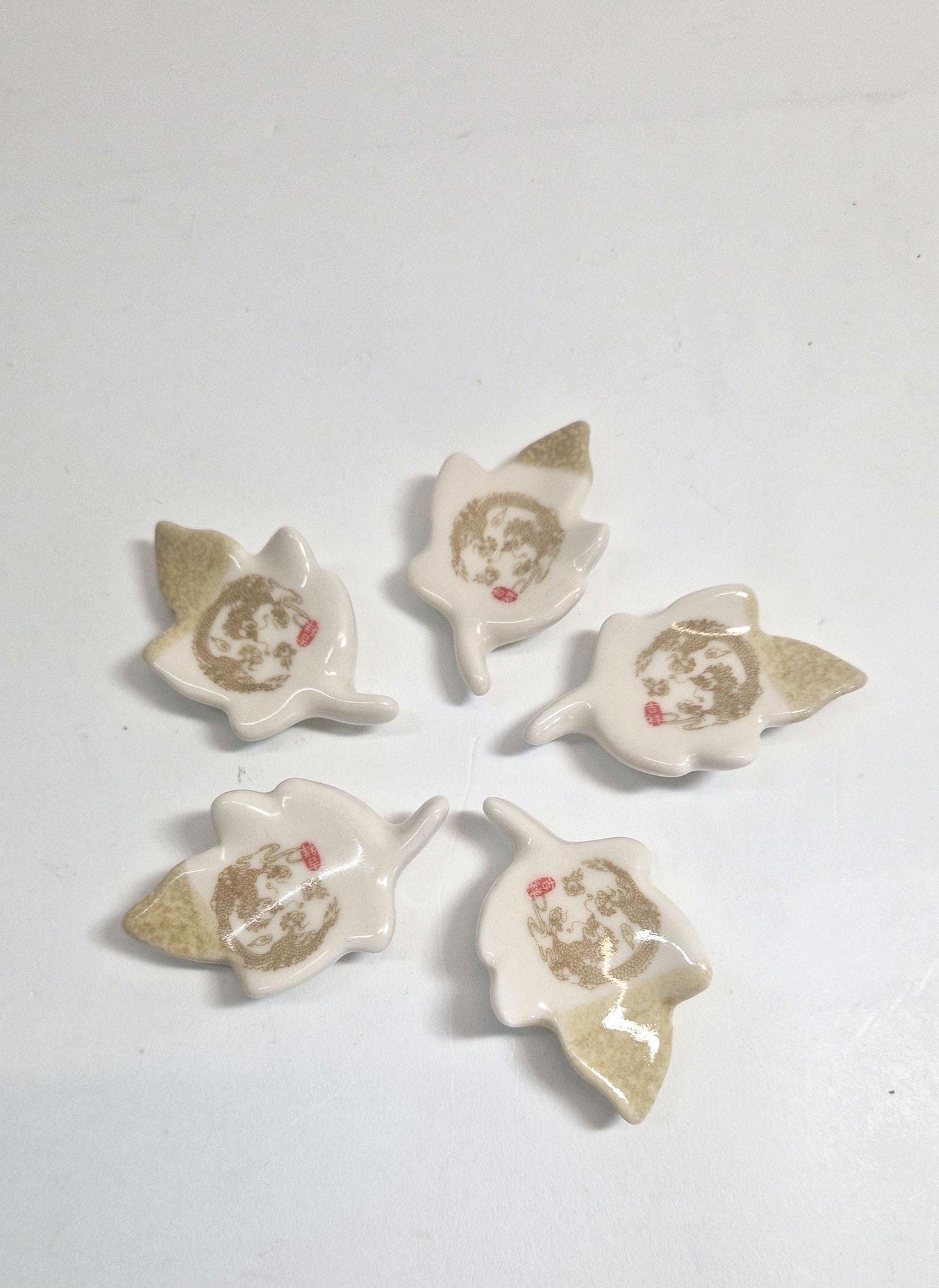 5 Chopstick Holders, Leaf Shaped with Dragon Design in Cream and Beige.