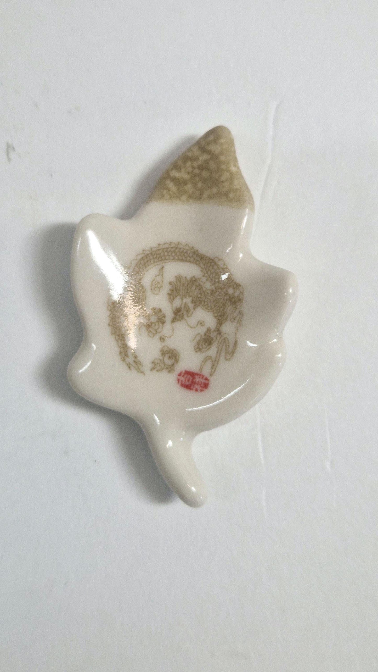 5 Chopstick Holders, Leaf Shaped with Dragon Design in Cream and Beige.